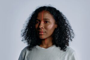 Close-up of a woman's face with a scanning line across it, illustrating the face-geometry scans at issue in the Neutrogena Skin360 biometric privacy settlement