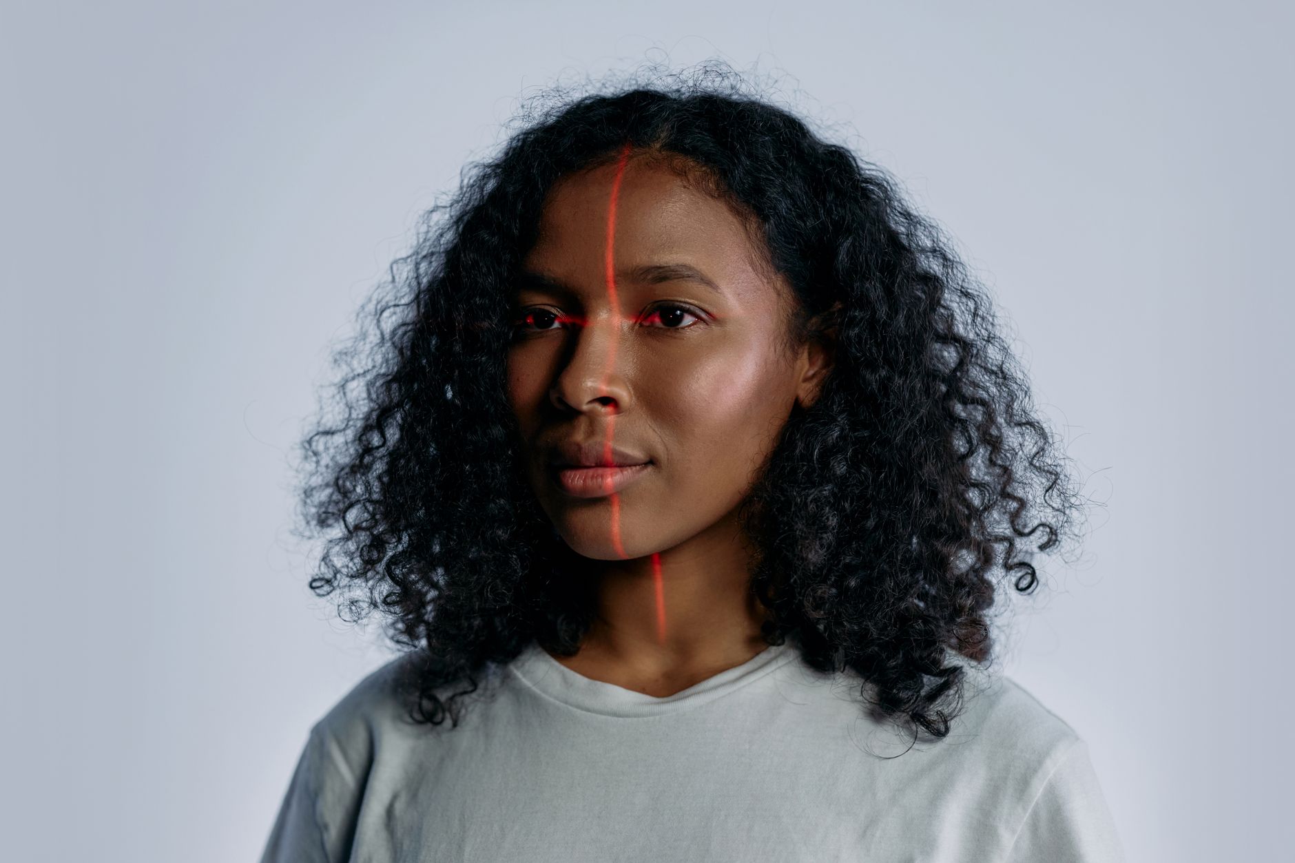Close-up of a woman's face with a scanning line across it, illustrating the face-geometry scans at issue in the Neutrogena Skin360 biometric privacy settlement
